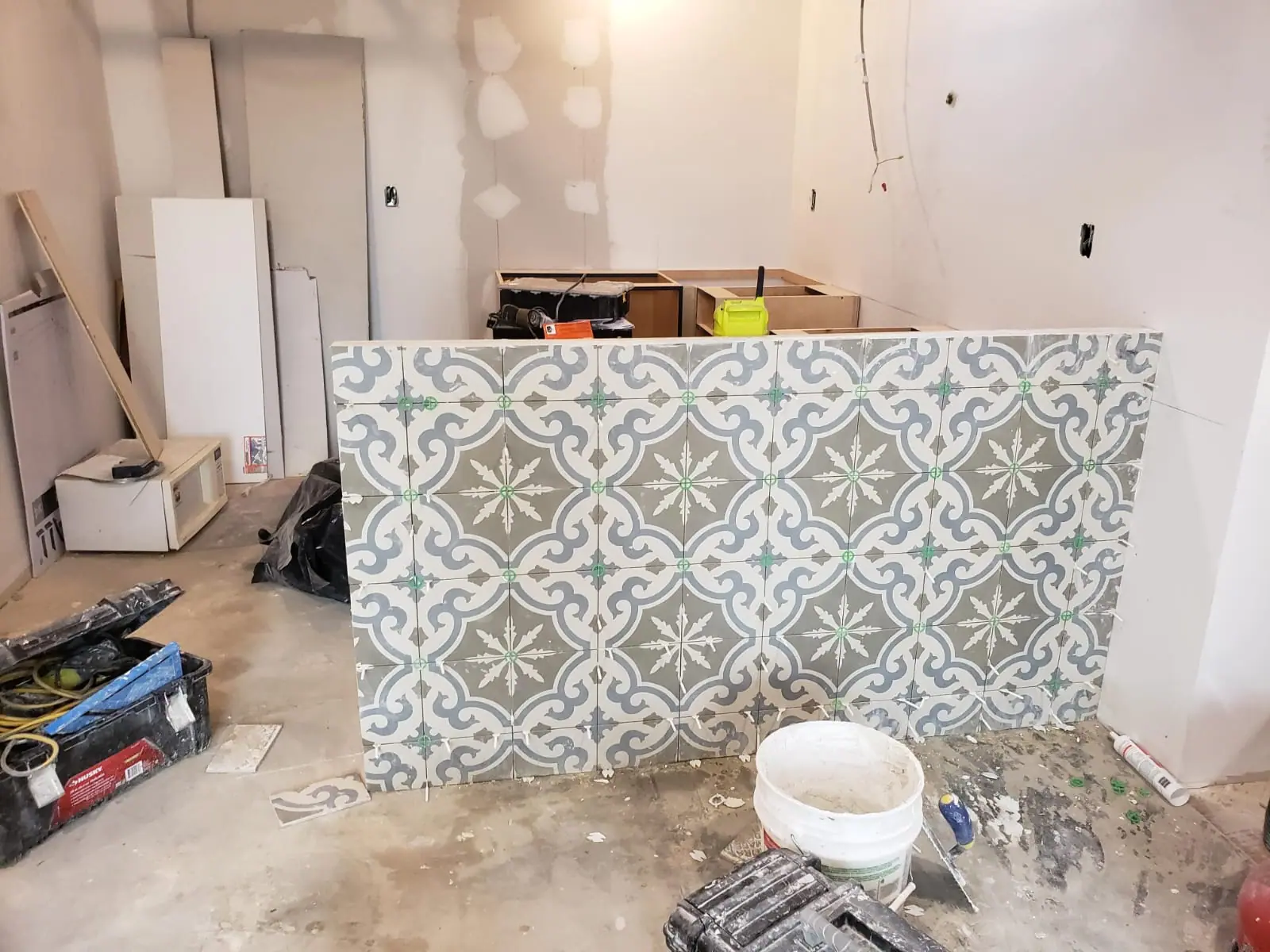Kitchen island being tiled during construction