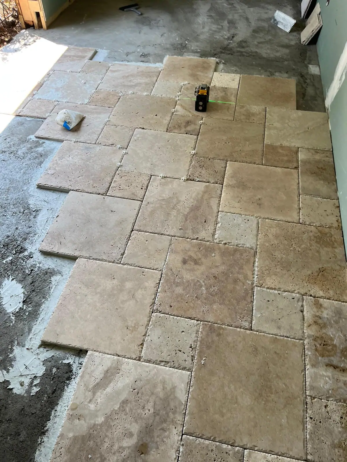 Travertine stones being set over the prepared base
